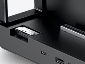 Close-up of a black electronic device with an open front drawer and a metal connector inside.