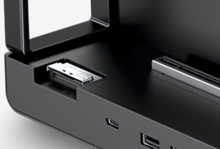 Close-up of a black electronic device with an open front drawer and a metal connector inside.