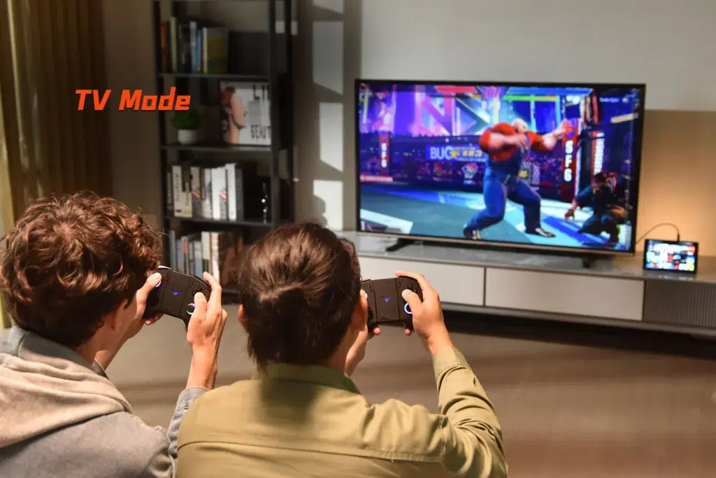 ONEXPLAYER X1 Mini 7 ONEXPLAYER X1 Mini in TV mode, connected to a large screen with two players gaming together using detached controllers, highlighting its versatility for multiplayer gaming on a bigger display.