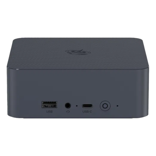 The front view of a compact Beelink EQI12 Mini PC in dark grey It features a USB A port a 35mm headphone jack a USB C port and a power button The casing has a textured design on the top with a circular logo