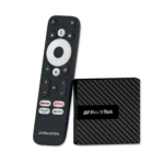 RockTek GB1 Android TV box shown alongside its dedicated remote control The compact device has a sleek textured design The remote features a circular navigation pad voice control button and dedicated buttons for popular streaming services like YouTube Netflix and Prime Video along with an Apps button for quick access to installed applications