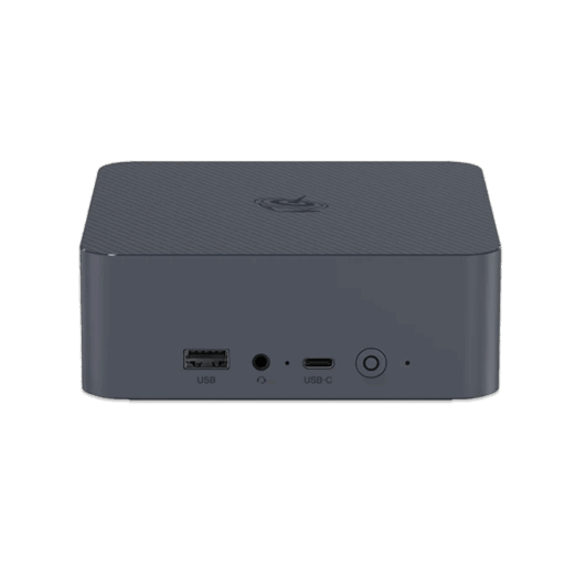 A straight on front view of a dark grey square shaped mini PC with rounded corners set against a solid dark green background The top surface has a subtle textured pattern and a circular logo The front panel features a USB A port a headphone jack a USB C port and a power button with a circular LED indicator All ports and buttons are labeled with white text