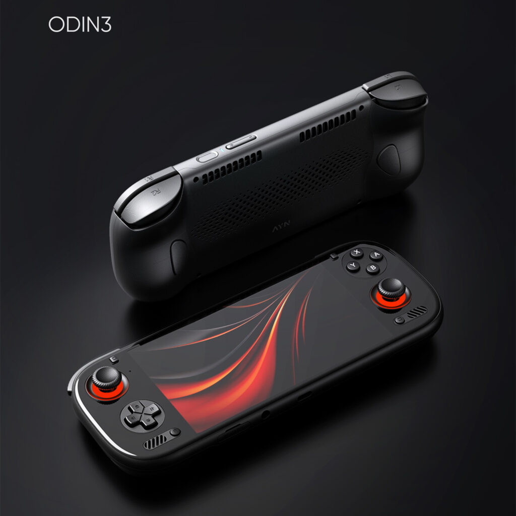 A pair of black AYN ODIN3 handheld gaming consoles is shown against a dark, featureless background. The foreground console is face-up, with its screen displaying a vibrant red and black abstract design. Its joysticks are prominently lit with a glowing red ring. The second console is positioned behind and above it, flipped over to show the back of the device, which features a textured grip and ventilation grilles. The text "ODIN3" is in the top left corner.