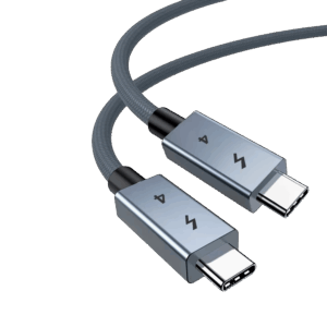 A close-up of a high-quality USB-4 cable featuring two USB-C connectors with space-grey metallic housings. The connectors are engraved with a lightning bolt icon and the number "4." The cable itself has a durable, grey braided nylon jacket, shown curved against a plain white background.