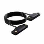 An image of the ONEXPLAYER APEX Battery Interface cable. The product consists of a long, coiled black cable connecting two identical, rectangular black plastic blocks. Each block features the "APEX battery interface" logo embossed on the top surface and is equipped with two small, gold-colored knurled thumbscrews at the ends for secure attachment. The entire assembly is displayed against a solid black background.