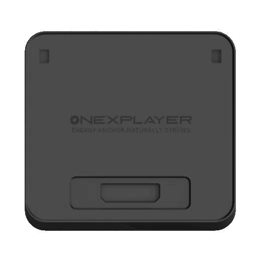 A top-down view of the ONEXPLAYER APEX Battery Dock, a square-shaped, matte black electronic accessory with rounded corners. The center of the device features the embossed ONEXPLAYER logo, followed by the slogan "ENERGY ANCHOR, NATURALLY STRONG". There are two small rectangular indentations near the top corners and a larger, recessed rectangular port or connection area located at the bottom center of the face.