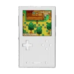 A front-facing view of the AYANEO Pocket DMG in a clean white/silver finish. The screen displays a colorful farming simulation game. The D-pad and action buttons are white with a translucent quality, matching the minimalist aesthetic of the console.