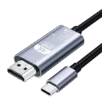 A studio photograph displays a metallic silver colored Type-C to HD adapter cable against a black background. The main body of the adapter features text in English: “4K UHD Type-C to HD Cable Model TH001 Rev: No.01 Made in China” alongside CE, WEEE, and FCC symbols. Connected to this metallic body are an HDMI male connector on one end and a black insulated cable on the opposite end. Additionally, a separate Type-C male connector, with its matching silver housing, is shown below the main body, also with its cable partially visible. All connections feature black heat shrink or plastic where the cables meet the connectors.
