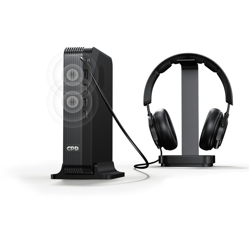 A marketing image showing the GPD device vertically docked. A cable connects its top audio jack to a pair of black over-ear headphones sitting on a stand. Faint white concentric circles emanate from the front of the unit, illustrating the built-in speaker functionality alongside the wired audio output.