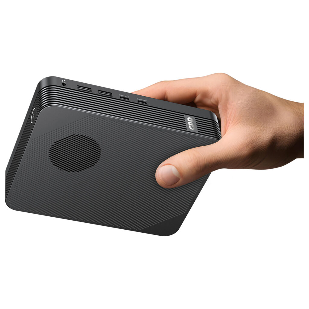 A person's hand holds the matte black GPD unit horizontally against a white background, highlighting its small, handheld form factor. The side profile clearly shows the headphone jack, dual USB-A ports, and dual USB4 V2.0 ports.