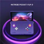 Open purple handheld gaming console with glowing purple ring lights and a vibrant screen; title 'RETROID POCKET FLIP 2' above it